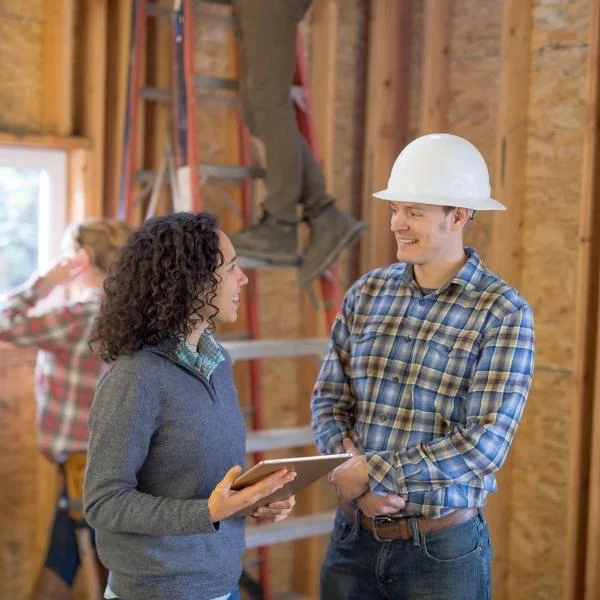 worker wearing hard hat talking to a woman lehi ut